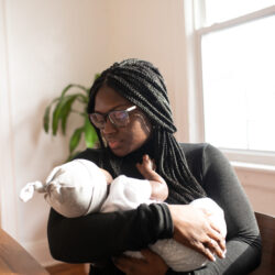 Black mother holding an infant