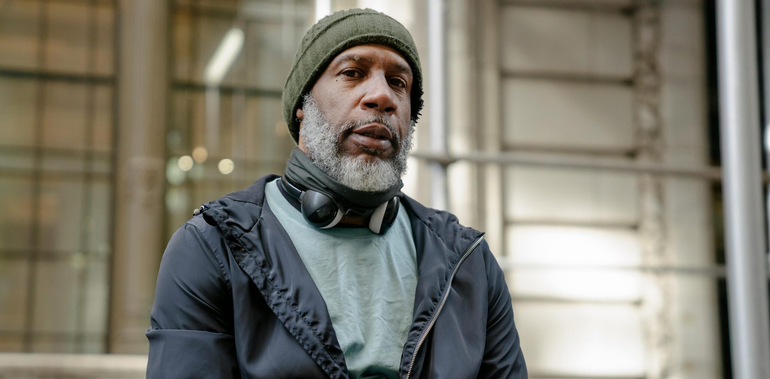 Elderly Black man wearing a beanie and sweatshirt