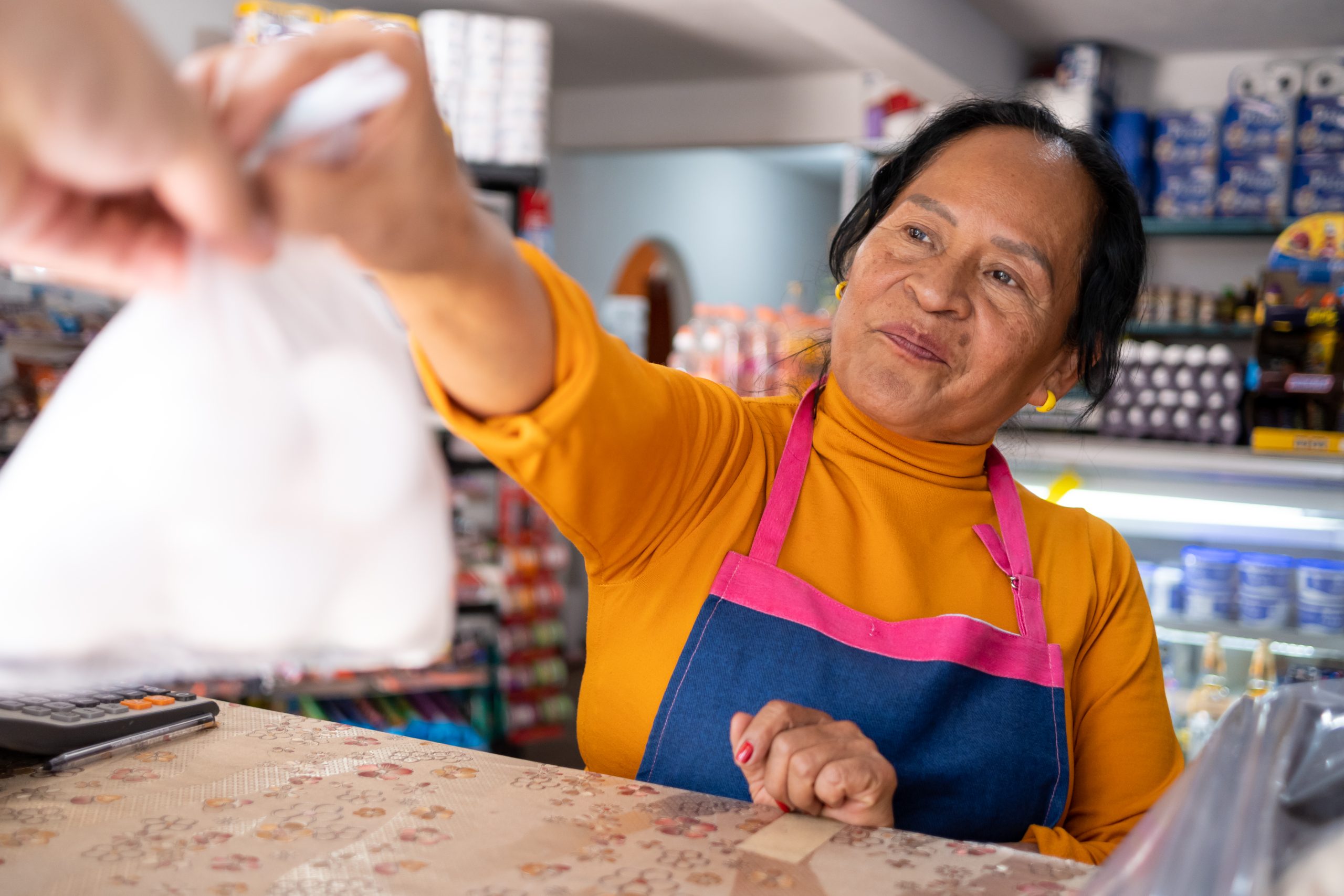 Elderly Mexican woman attending a grocery store